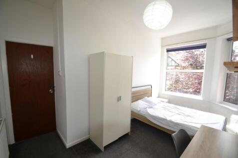 Bright and cozy bedroom featuring a single bed,...