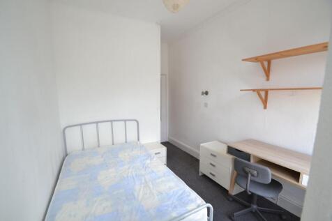 A clean and bright student bedroom featuring a ...