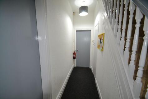 Bright, well-maintained hallway with clean whit...