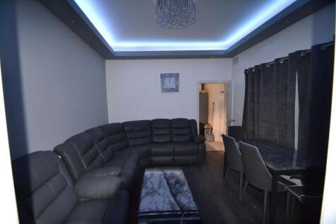 Modern and spacious living room featuring a lar...