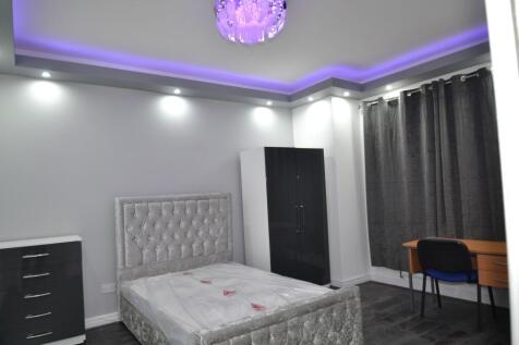 Modern bedroom featuring a plush upholstered be...