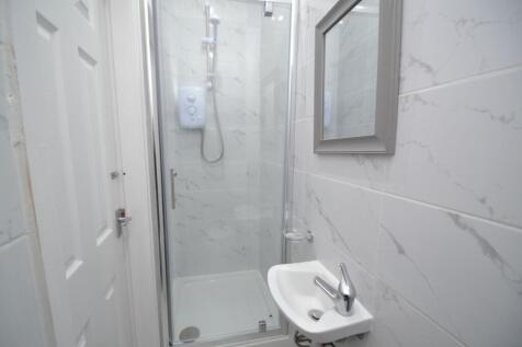 Well-maintained bathroom featuring a shower wit...