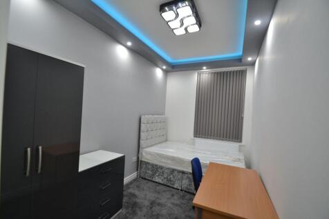 A modern double bedroom featuring a stylish hea...