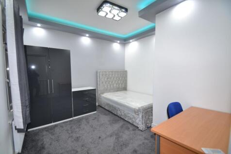 A modern, neatly maintained bedroom featuring a...