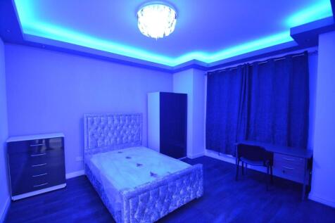 Spacious and modern bedroom featuring a plush u...