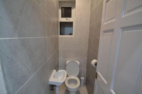 A clean, modern bathroom with neutral grey tile...