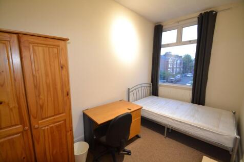 A cozy student bedroom featuring a single bed, ...