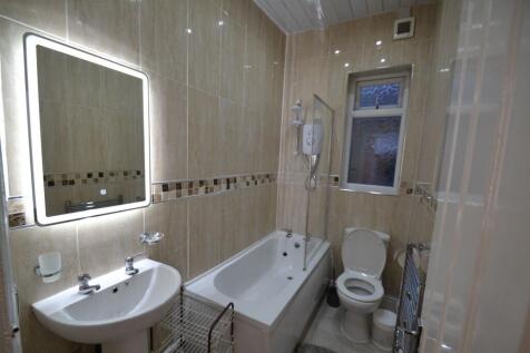 Modern bathroom featuring a double sink with a ...