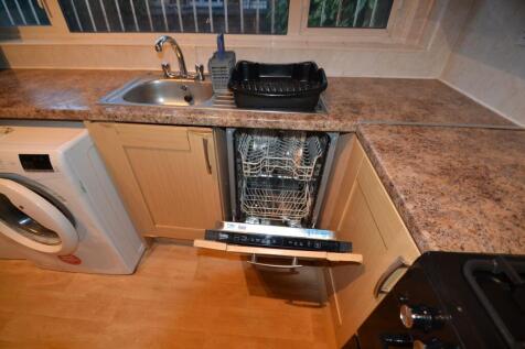 A well-maintained kitchen features a clean coun...