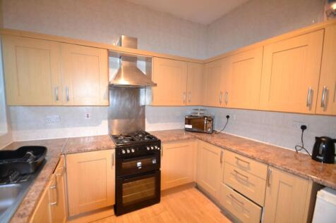 A well-maintained kitchen with ample wooden cab...