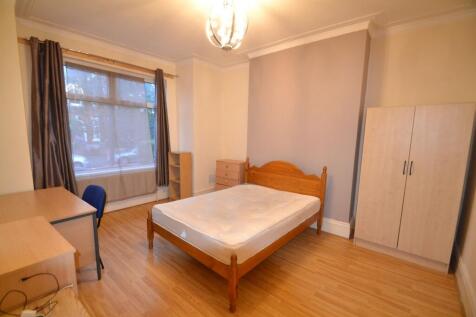 A cozy, well-maintained bedroom featuring a woo...