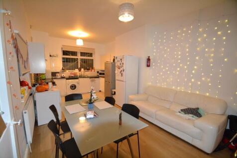 A cozy and well-lit living room featuring warm ...