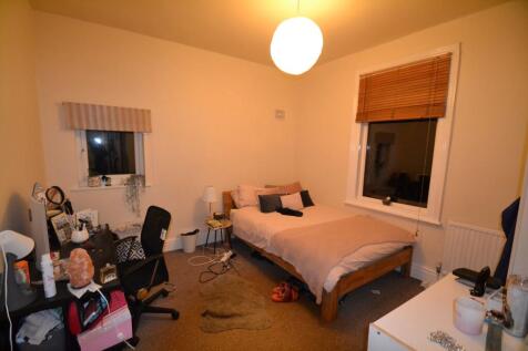 Cozy living room with warm lighting, featuring ...