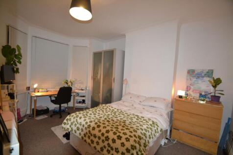 A cozy bedroom with a comfortable double bed, a...