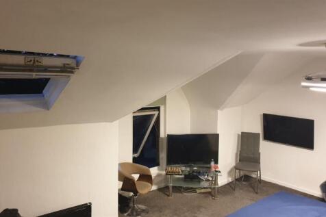 Bright attic-style bedroom with sloped ceilings...