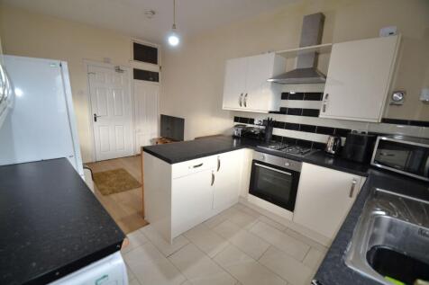 Modern fitted kitchen with gloss white cabinets...