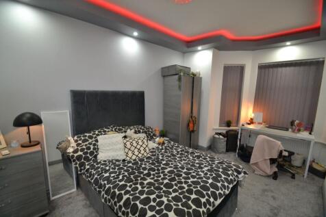 Stylish master bedroom with a plush upholstered...