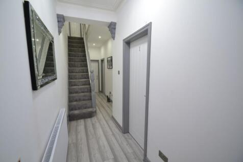 A clean and well-maintained hallway featuring a...