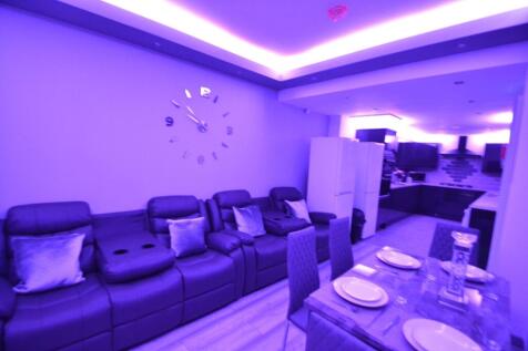 Modern living room illuminated with ambient pur...