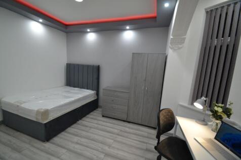 A modern, well-lit bedroom featuring a stylish ...