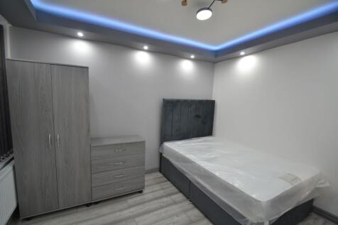 Modern double bedroom featuring a spacious bed ...