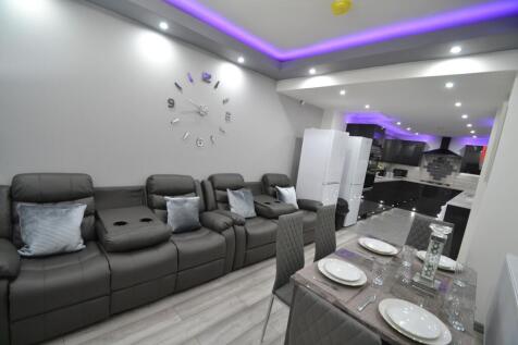 Bright and modern living room with stylish dark...