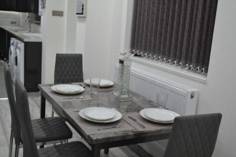 Contemporary eat-in kitchen with a rustic woode...