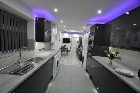 Modern, sleek kitchen with glossy black cabinet...
