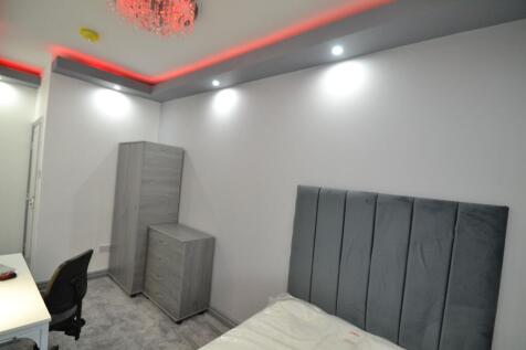 A modern bedroom featuring a comfortable bed wi...