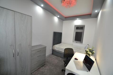 A cozy single bedroom featuring a single bed, a...