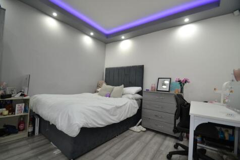 Bright, modern double bedroom with a plush upho...