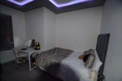 Comfortable double bedroom with a plush upholst...