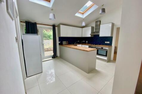 Bright, contemporary kitchen with skylights and...