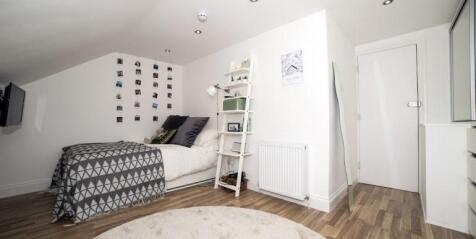 Bright, modern double bedroom with a patterned ...