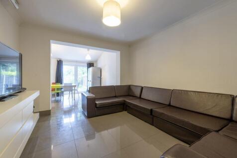 Bright, modern living room with a large L-shape...