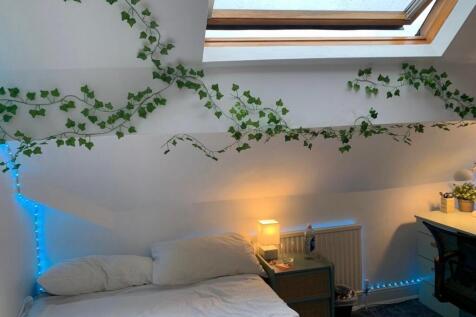 A cozy and well-maintained bedroom with a large...