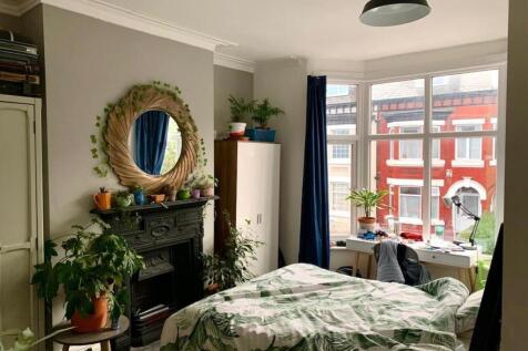 A bright, nicely maintained bedroom featuring a...