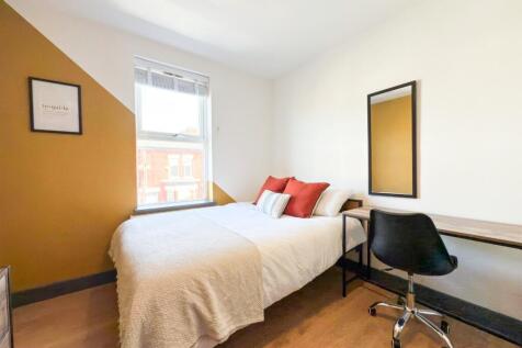 Bright, neatly presented bedroom with a comfort...