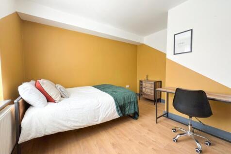 Bright, neatly presented bedroom with a comfort...