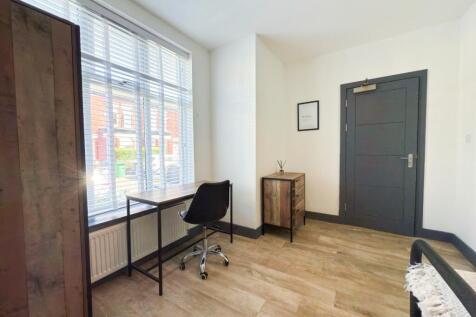 Bright, modern entrance hallway with large fron...