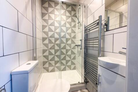 Bright, modern bathroom with a contemporary til...