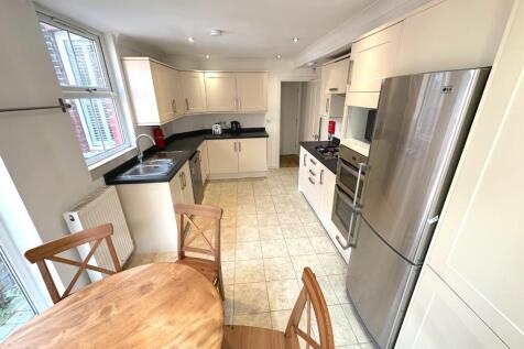 Bright modern kitchen with large fridge, integr...