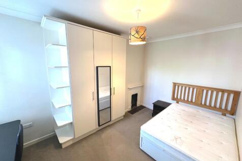 Bright furnished bedroom with a double bed, bui...