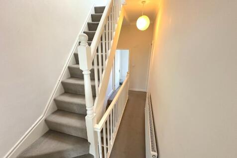 Bright, well-maintained carpeted staircase and ...