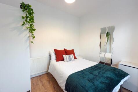 A bright and spacious master bedroom featuring ...