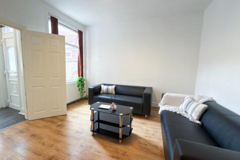 A bright and welcoming living room featuring co...