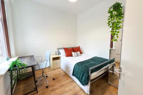 Bright and inviting master bedroom with ample n...