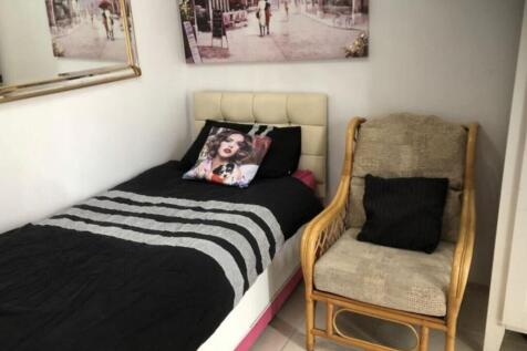 A cozy and inviting single bedroom with stylish...