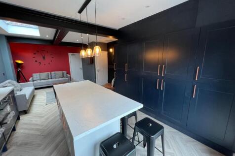 A modern, spacious living room featuring sleek ...