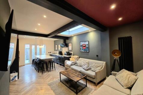 A spacious, modern living room with ample seati...